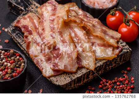 Fried smoked bacon slices, ham, jamon, or prosciutto strips for cooking. Fried bacon Fried smoked bacon slices, ham, jamon, or prosciutto strips for cooking. Fried bacon 135762768
