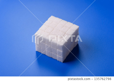 Sweet white sugar cubes as a source of glucose. White sugar cubes as a food background Sweet white sugar cubes as a source of glucose. White sugar cubes as a food background 135762798
