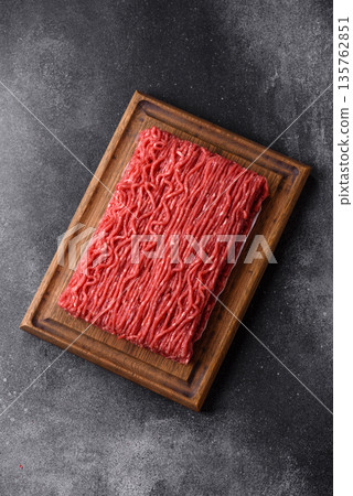 Raw ground beef or pork for burgers or meatballs with salt and spices. Raw ground beef Raw ground beef or pork for burgers or meatballs with salt and spices. Raw ground beef 135762851