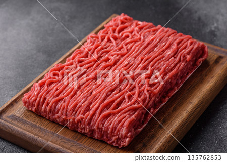 Raw ground beef or pork for burgers or meatballs with salt and spices. Raw ground beef Raw ground beef or pork for burgers or meatballs with salt and spices. Raw ground beef 135762853