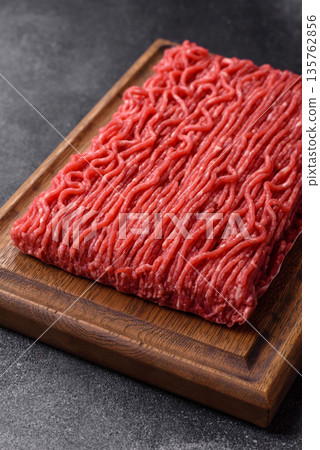 Raw ground beef or pork for burgers or meatballs with salt and spices. Raw ground beef Raw ground beef or pork for burgers or meatballs with salt and spices. Raw ground beef 135762856