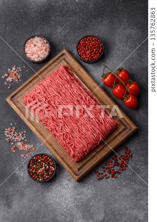 Raw ground beef or pork for burgers or meatballs with salt and spices. Raw ground beef 135762863