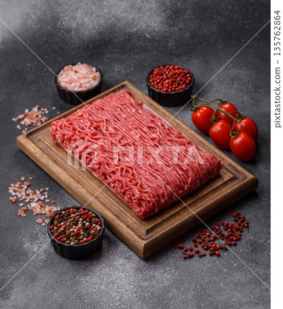 Raw ground beef or pork for burgers or meatballs with salt and spices. Raw ground beef 135762864
