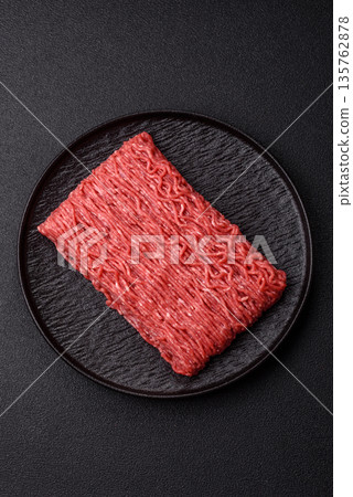 Raw ground beef or pork for burgers or meatballs with salt and spices. Raw ground beef Raw ground beef or pork for burgers or meatballs with salt and spices. Raw ground beef 135762878