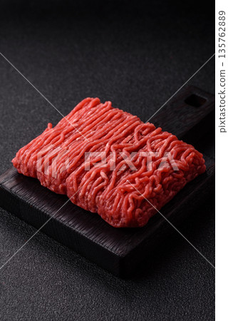 Raw ground beef or pork for burgers or meatballs with salt and spices. Raw ground beef 135762889