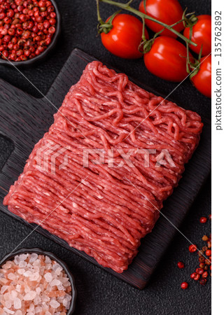Raw ground beef or pork for burgers or meatballs with salt and spices. Raw ground beef Raw ground beef or pork for burgers or meatballs with salt and spices. Raw ground beef 135762892