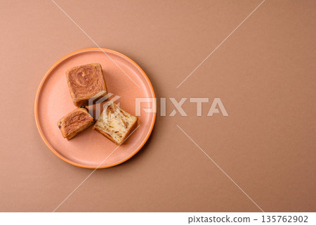 A French cube croissant with chocolate filling, a sweet breakfast pastry. Cube croissant A French cube croissant with chocolate filling, a sweet breakfast pastry. Cube croissant 135762902