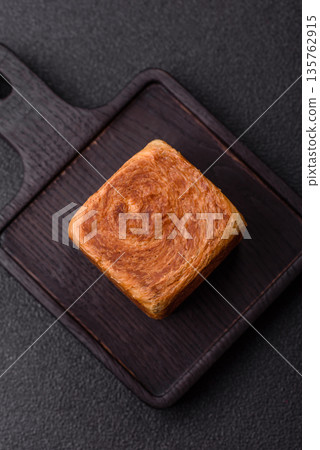 A French cube croissant with chocolate filling, a sweet breakfast pastry. Cube croissant A French cube croissant with chocolate filling, a sweet breakfast pastry. Cube croissant 135762915
