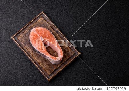 Fish, raw salmon steak, fresh seafood for grilling with salt, spices, and herbs. Raw salmon steak 135762919