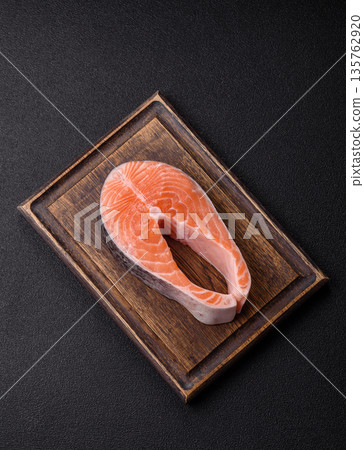 Fish, raw salmon steak, fresh seafood for grilling with salt, spices, and herbs. Raw salmon steak 135762920