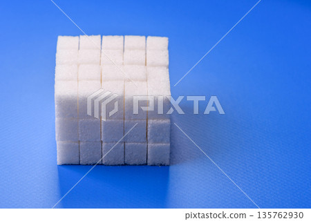 Sweet white sugar cubes as a source of glucose. White sugar cubes as a food background Sweet white sugar cubes as a source of glucose. White sugar cubes as a food background 135762930