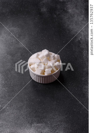 Sweet white sugar cubes as a source of glucose. White sugar cubes as a food background 135762937