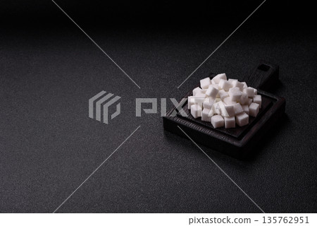 Sweet white sugar cubes as a source of glucose. White sugar cubes as a food background Sweet white sugar cubes as a source of glucose. White sugar cubes as a food background 135762951