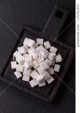 Sweet white sugar cubes as a source of glucose. White sugar cubes as a food background Sweet white sugar cubes as a source of glucose. White sugar cubes as a food background 135762957