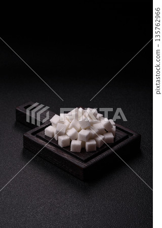 Sweet white sugar cubes as a source of glucose. White sugar cubes as a food background 135762966