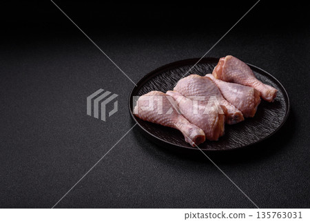 Chicken meat, raw drumsticks on the bone for grilling with salt and spices. Raw chicken drumsticks Chicken meat, raw drumsticks on the bone for grilling with salt and spices. Raw chicken drumsticks 135763031