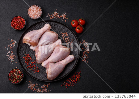 Chicken meat, raw drumsticks on the bone for grilling with salt and spices. Raw chicken drumsticks Chicken meat, raw drumsticks on the bone for grilling with salt and spices. Raw chicken drumsticks 135763044