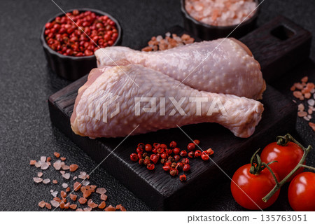 Chicken meat, raw drumsticks on the bone for grilling with salt and spices. Raw chicken drumsticks Chicken meat, raw drumsticks on the bone for grilling with salt and spices. Raw chicken drumsticks 135763051