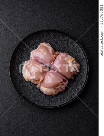 Chicken meat, raw boneless thigh fillets for grilling with salt. Raw chicken thigh fillets Chicken meat, raw boneless thigh fillets for grilling with salt. Raw chicken thigh fillets 135763081