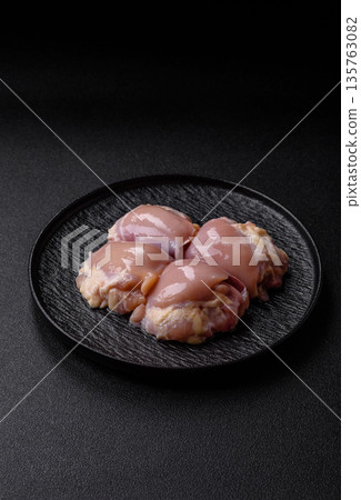 Chicken meat, raw boneless thigh fillets for grilling with salt. Raw chicken thigh fillets Chicken meat, raw boneless thigh fillets for grilling with salt. Raw chicken thigh fillets 135763082