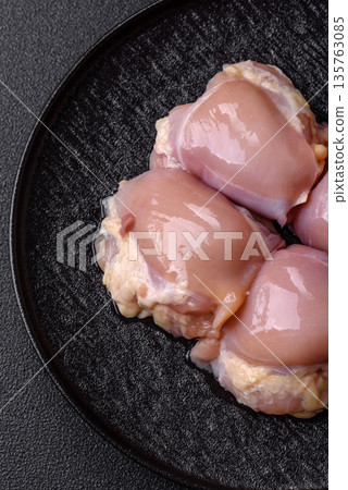 Chicken meat, raw boneless thigh fillets for grilling with salt. Raw chicken thigh fillets 135763085