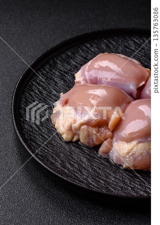Chicken meat, raw boneless thigh fillets for grilling with salt. Raw chicken thigh fillets 135763086
