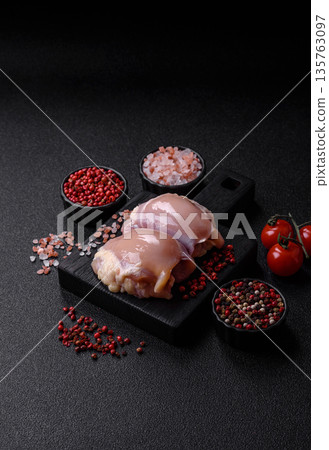 Chicken meat, raw boneless thigh fillets for grilling with salt. Raw chicken thigh fillets 135763097