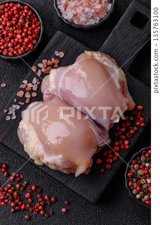 Chicken meat, raw boneless thigh fillets for grilling with salt. Raw chicken thigh fillets Chicken meat, raw boneless thigh fillets for grilling with salt. Raw chicken thigh fillets 135763100