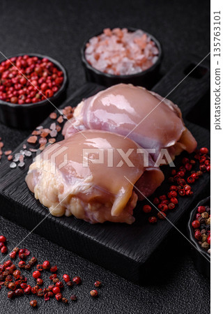 Chicken meat, raw boneless thigh fillets for grilling with salt. Raw chicken thigh fillets 135763101