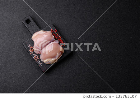 Chicken meat, raw boneless thigh fillets for grilling with salt. Raw chicken thigh fillets 135763107