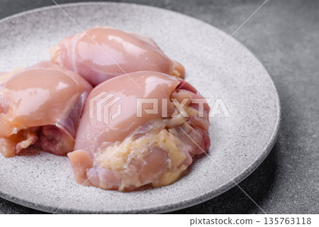 Chicken meat, raw boneless thigh fillets for grilling with salt. Raw chicken thigh fillets 135763118