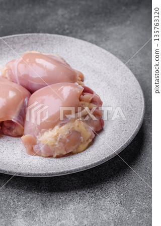 Chicken meat, raw boneless thigh fillets for grilling with salt. Raw chicken thigh fillets Chicken meat, raw boneless thigh fillets for grilling with salt. Raw chicken thigh fillets 135763120