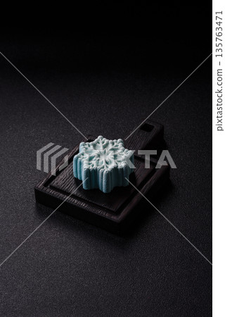 Christmas mochi, mooncake, or cheesecake shaped like a snowflake. Christmas mochi or cheesecake 135763471