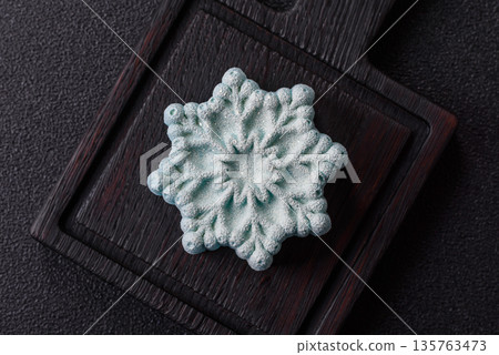 Christmas mochi, mooncake, or cheesecake shaped like a snowflake. Christmas mochi or cheesecake 135763473