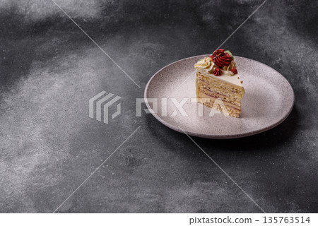 A slice of sweet layered cake with white cream for a birthday or holiday. A slice of cake A slice of sweet layered cake with white cream for a birthday or holiday. A slice of cake 135763514