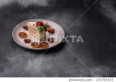 A slice of sweet layered cake with white cream for a birthday or holiday. A slice of cake A slice of sweet layered cake with white cream for a birthday or holiday. A slice of cake 135763525