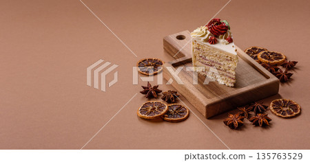 A slice of sweet layered cake with white cream for a birthday or holiday. A slice of cake A slice of sweet layered cake with white cream for a birthday or holiday. A slice of cake 135763529