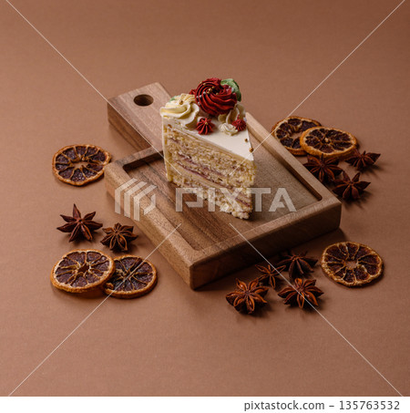 A slice of sweet layered cake with white cream for a birthday or holiday. A slice of cake A slice of sweet layered cake with white cream for a birthday or holiday. A slice of cake 135763532