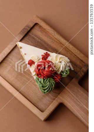 A slice of sweet layered cake with white cream for a birthday or holiday. A slice of cake A slice of sweet layered cake with white cream for a birthday or holiday. A slice of cake 135763539