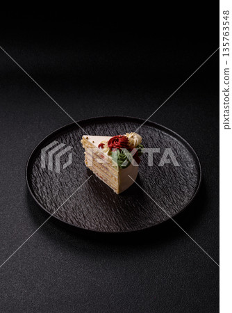 A slice of sweet layered cake with white cream for a birthday or holiday. A slice of cake 135763548