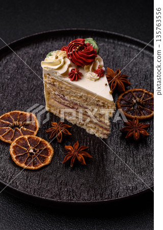 A slice of sweet layered cake with white cream for a birthday or holiday. A slice of cake A slice of sweet layered cake with white cream for a birthday or holiday. A slice of cake 135763556