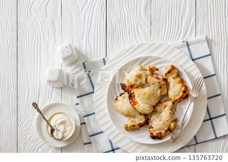 Baked boneless chicken thighs and yogurt dip bowl Baked boneless chicken thighs and yogurt dip bowl 135763720