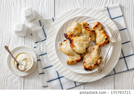 Baked boneless chicken thighs and yogurt dip bowl Baked boneless chicken thighs and yogurt dip bowl 135763721