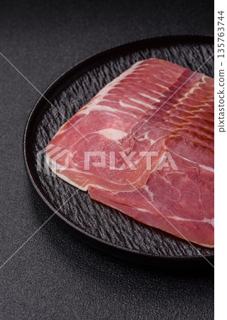 Meat, ham, jamon, or prosciutto sliced for breakfast bruschetta. Sliced ham, jamon, or prosciutto Meat, ham, jamon, or prosciutto sliced for breakfast bruschetta. Sliced ham, jamon, or prosciutto 135763744