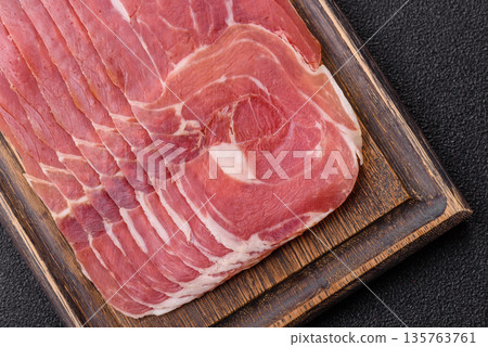Meat, ham, jamon, or prosciutto sliced for breakfast bruschetta. Sliced ham, jamon, or prosciutto 135763761