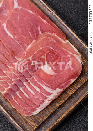Meat, ham, jamon, or prosciutto sliced for breakfast bruschetta. Sliced ham, jamon, or prosciutto Meat, ham, jamon, or prosciutto sliced for breakfast bruschetta. Sliced ham, jamon, or prosciutto 135763762