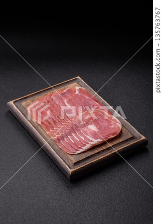 Meat, ham, jamon, or prosciutto sliced for breakfast bruschetta. Sliced ham, jamon, or prosciutto Meat, ham, jamon, or prosciutto sliced for breakfast bruschetta. Sliced ham, jamon, or prosciutto 135763767