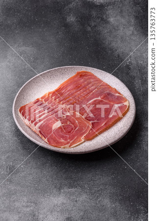 Meat, ham, jamon, or prosciutto sliced for breakfast bruschetta. Sliced ham, jamon, or prosciutto Meat, ham, jamon, or prosciutto sliced for breakfast bruschetta. Sliced ham, jamon, or prosciutto 135763773