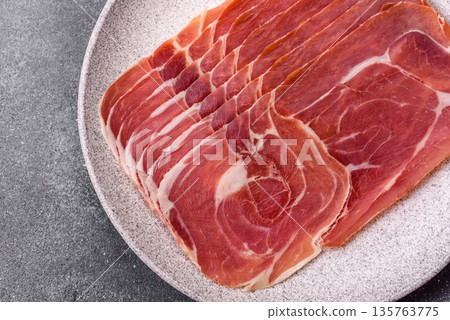 Meat, ham, jamon, or prosciutto sliced for breakfast bruschetta. Sliced ham, jamon, or prosciutto 135763775