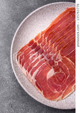 Meat, ham, jamon, or prosciutto sliced for breakfast bruschetta. Sliced ham, jamon, or prosciutto Meat, ham, jamon, or prosciutto sliced for breakfast bruschetta. Sliced ham, jamon, or prosciutto 135763776